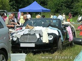 The effects of the crisis: one Bentley as clothes support in  a market