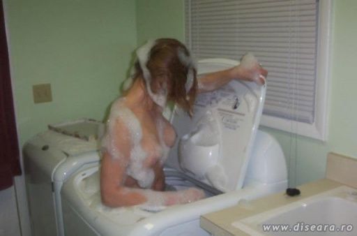 How a blonde is using a clothes washing machine